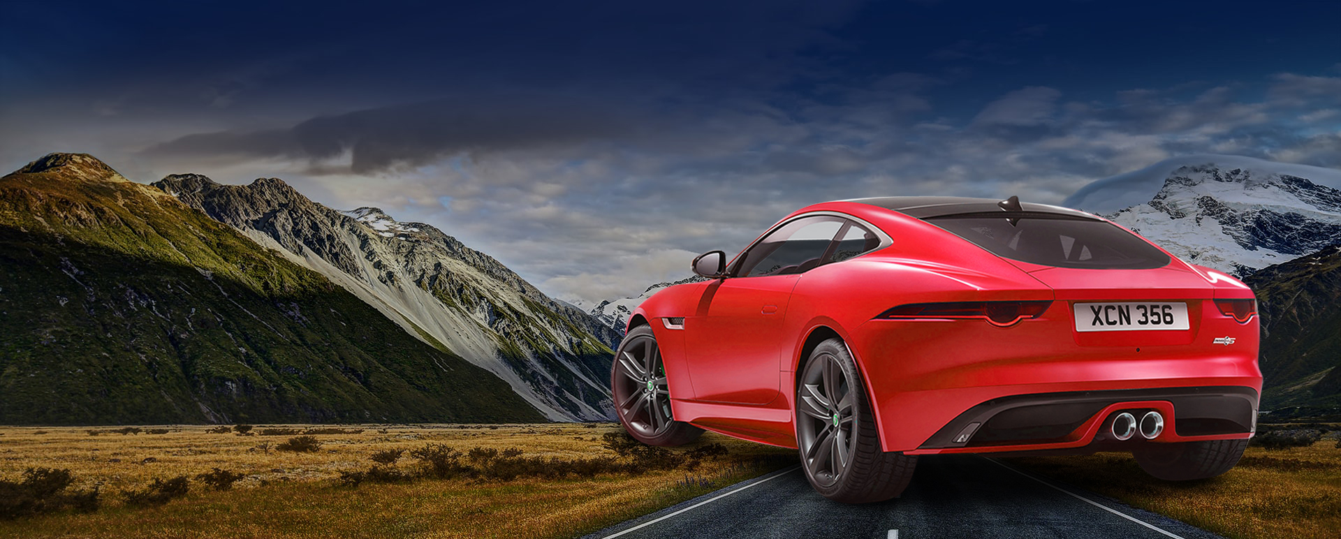 Red performance car in the mountains